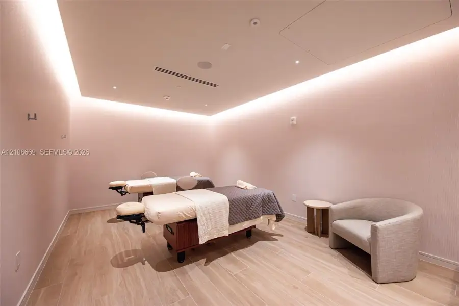 Interior space featuring wood-finish flooring, recessed perimeter lighting, and neutral wall tones