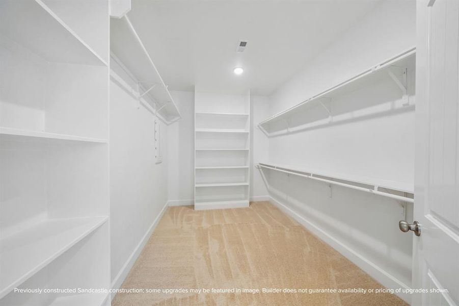 Primary Walk-In Closet – An expansive closet with built-in shelving and rods offers all the storage you need for an organized lifestyle.