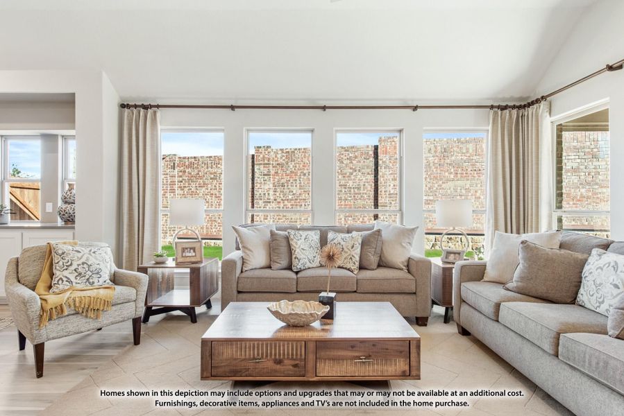 Living room with gray sofas, wood coffee table, and large windows with neutral curtains Living room with gray sofas, wood coffee table, and large windows with neutral curtains