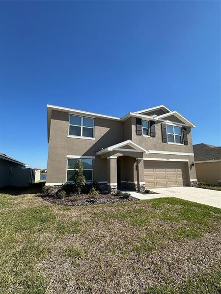 Front exterior of a new home in Berry Bay, Wimauma, FL, highlighting curb appeal (Image 5).