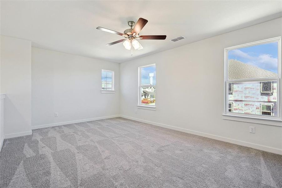 Spare room featuring ceiling fan and light colored carpet