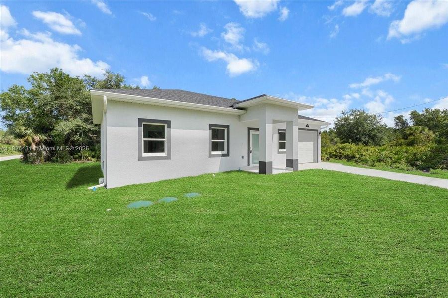 Front exterior of a new home in , Lehigh Acres, FL, highlighting curb appeal (Image 8). Front exterior of a new home in , Lehigh Acres, FL, highlighting curb appeal (Image 8).