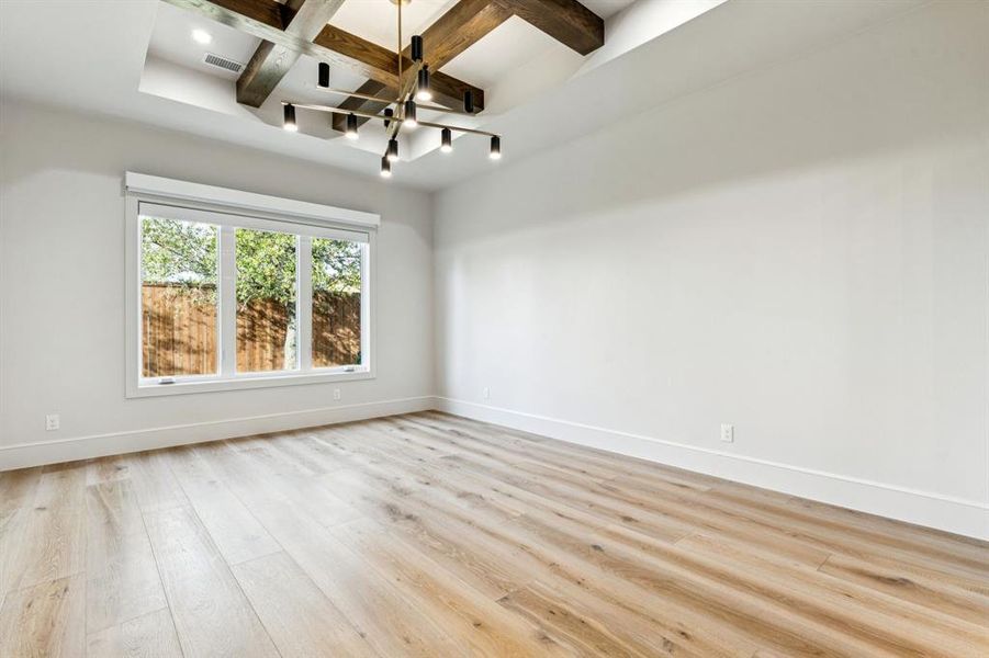 Primary bedroom with upgraded ceiling beams Primary bedroom with upgraded ceiling beams