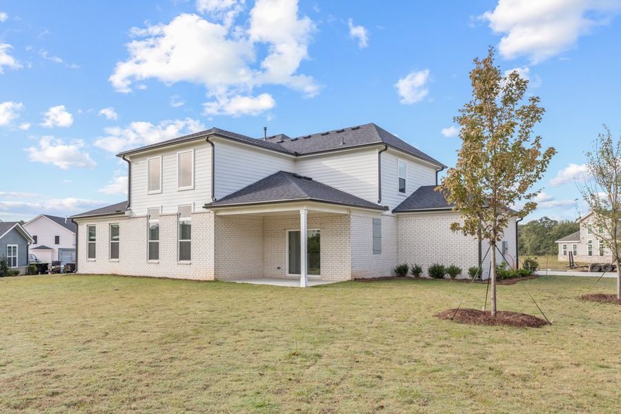 A house with a tree in the front yard.