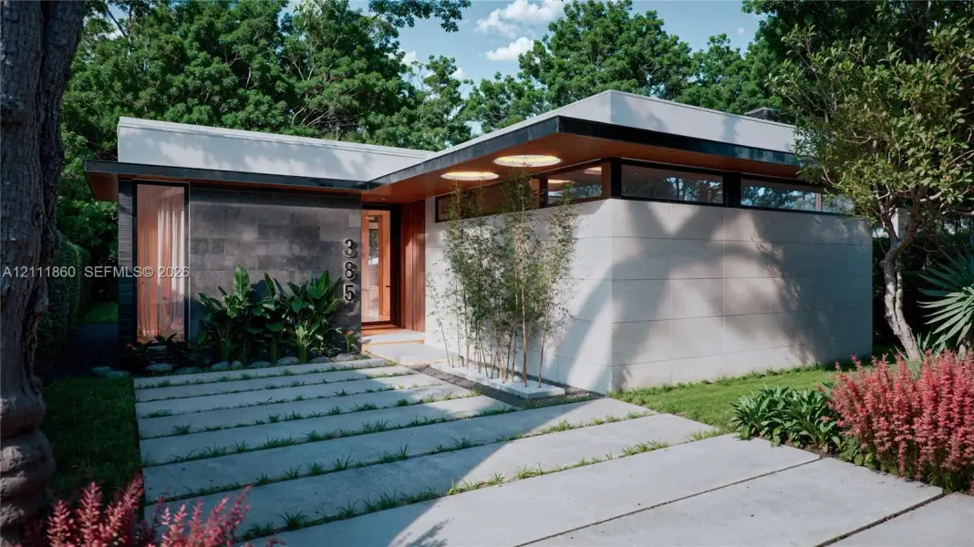 Modern architectural exterior featuring smooth stone facade, dark textured stone accents, clerestory windows, cantilevered roofline with wood-toned soffits, and geometric concrete paver driveway Modern architectural exterior featuring smooth stone facade, dark textured stone accents, clerestory windows, cantilevered roofline with wood-toned soffits, and geometric concrete paver driveway