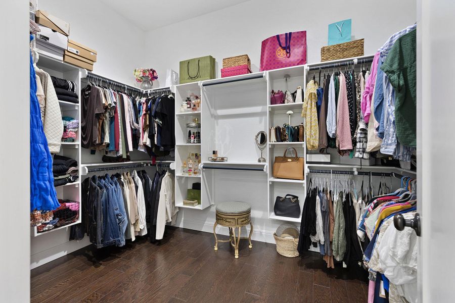 Walk in closet with dark wood-type flooring Walk in closet with dark wood-type flooring