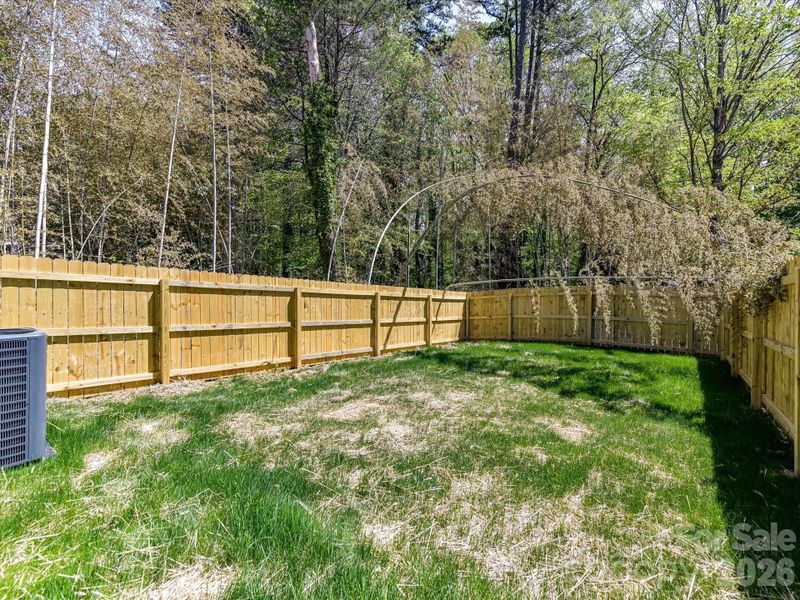Fully fenced backyard with a privacy fence offers a private outdoor space perfect for relaxing, entertaining, or pets to play freely.