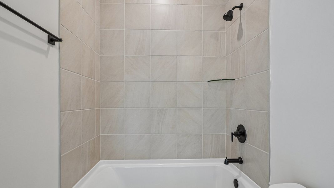 Private guest bathroom with tiled shower