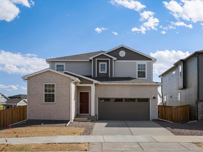 Front exterior of a new home in Ridgeline Vista: The Flora Collection, Brighton, CO, highlighting curb appeal (Image 1). Front exterior of a new home in Ridgeline Vista: The Flora Collection, Brighton, CO, highlighting curb appeal (Image 1).