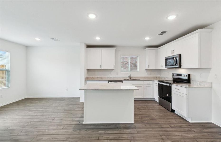 Bright kitchen with oversized island *real home pictured