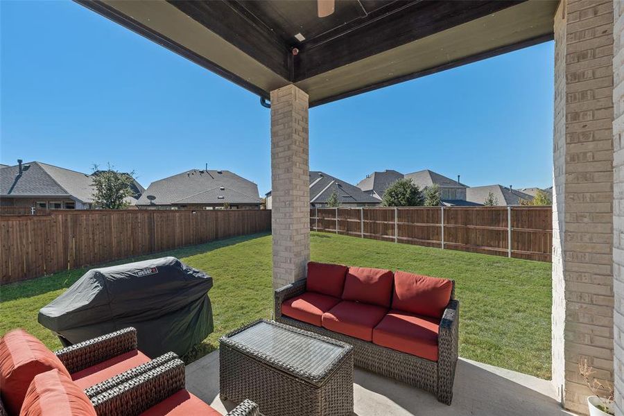 Fenced backyard featuring an outdoor hangout area, a patio area, and a residential view