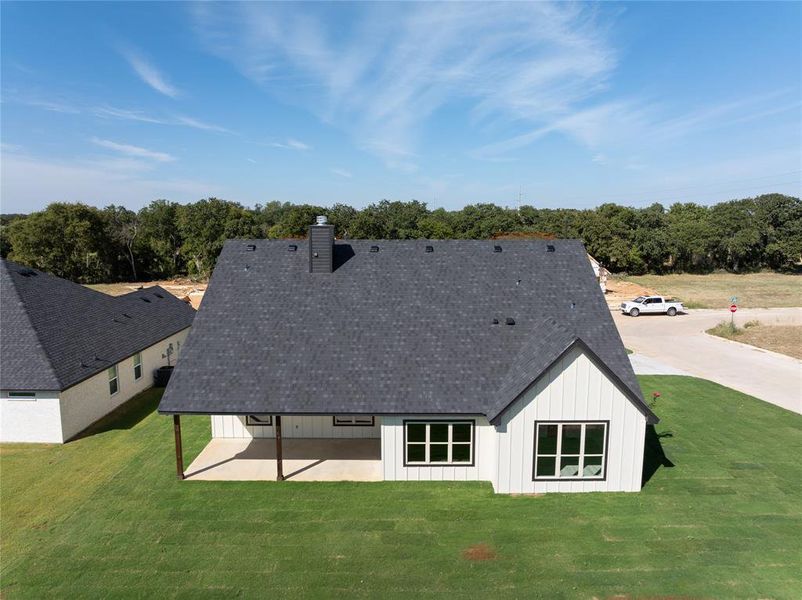 Back view of the home, large pack porch with lighting, fan and wired for outdoor entertaining.