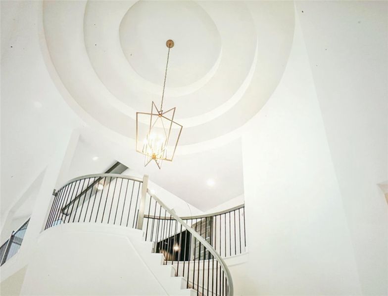 Step into sophistication with this signature Westin Homes design, showcasing a stunning rotunda ceiling that highlights the grand foyer. This impressive entryway sets the tone for the rest of the home, featuring architectural elegance, soaring ceilings, and refined craftsmanship. The dramatic rotunda creates a striking first impression, blending timeless luxury with Westin’s signature attention to detail.