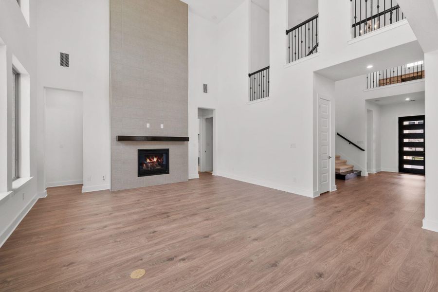 Family Room with soaring ceiling & fireplace