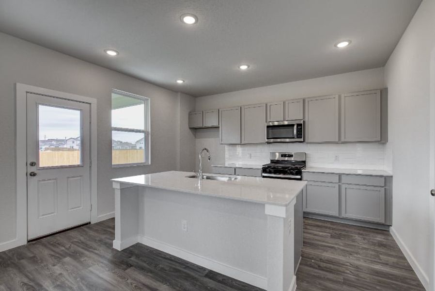 A kitchen with white cabinets. A kitchen with white cabinets.