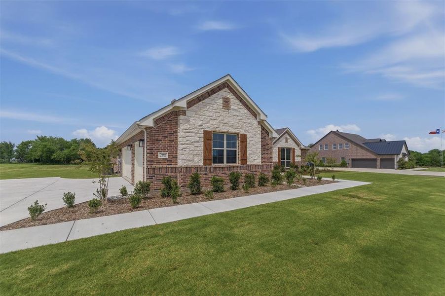 Brick and stone exterior with architectural shingles and wood window shutters Brick and stone exterior with architectural shingles and wood window shutters