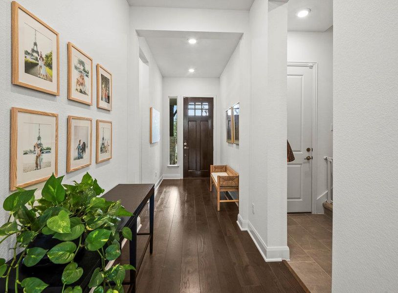 Entrance foyer featuring recessed lighting, baseboards, and dark wood-style flooring