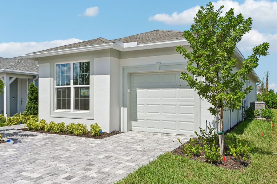 Front exterior of a new home in Harbor Isle, Vero Beach, FL, highlighting curb appeal (Image 25).