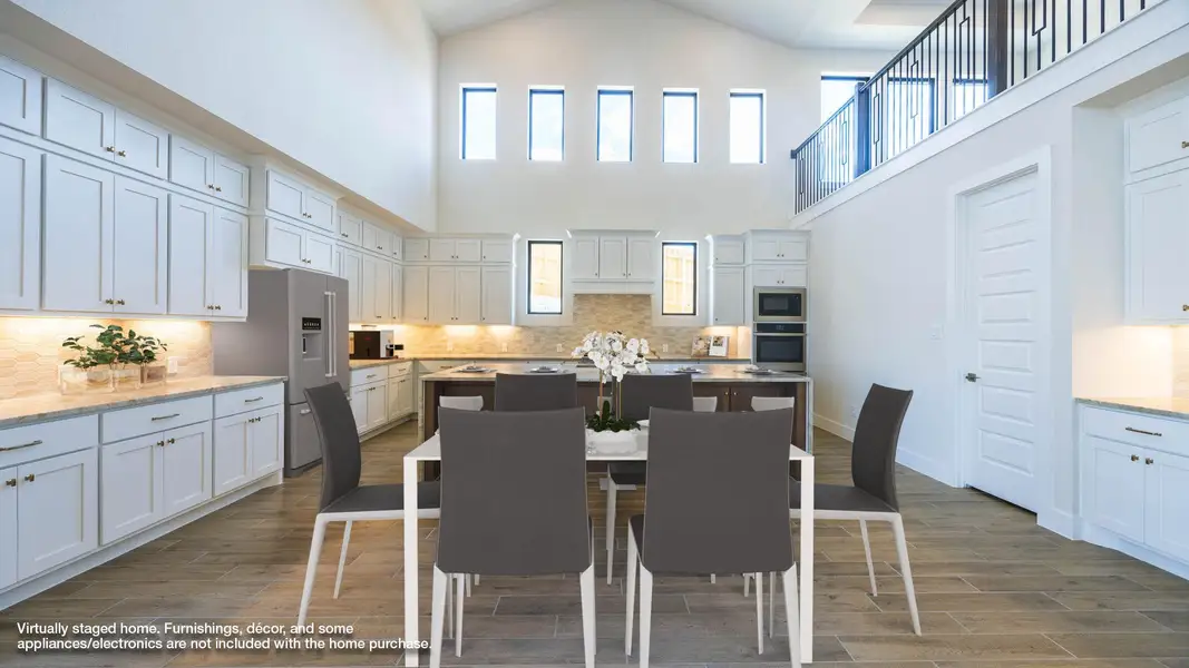 Dining area featuring wood tiled floors and high vaulted ceiling Dining area featuring wood tiled floors and high vaulted ceiling