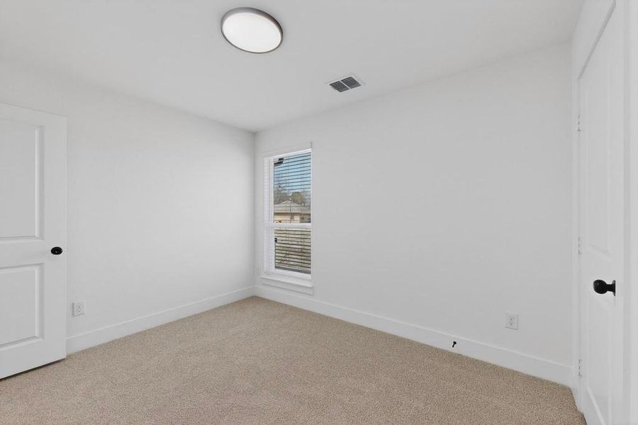 Empty room with baseboards and light carpet