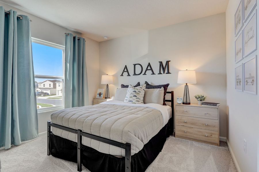 A bedroom with a large window.