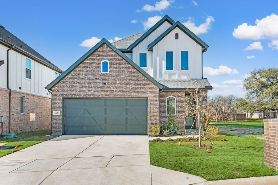 Front exterior of a new home in The Resort on Eagle Mt. Lake, Fort Worth, TX, highlighting curb appeal (Image 1). Front exterior of a new home in The Resort on Eagle Mt. Lake, Fort Worth, TX, highlighting curb appeal (Image 1).