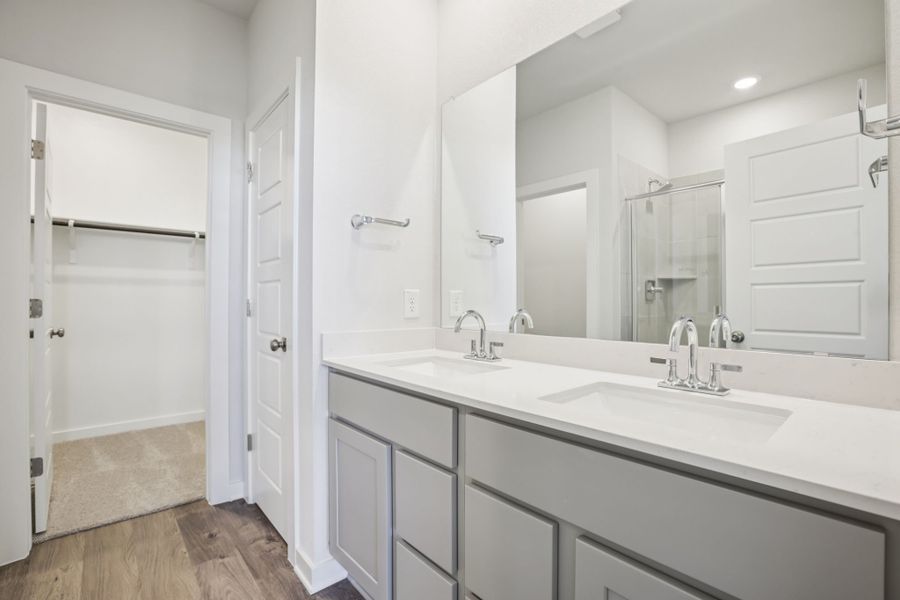 A bathroom with white cabinets.