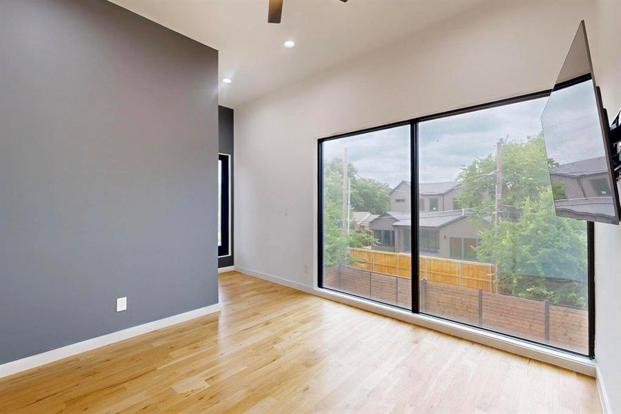 Spare room featuring light wood-style floors, a ceiling fan, healthy amount of natural light, and recessed lighting Spare room featuring light wood-style floors, a ceiling fan, healthy amount of natural light, and recessed lighting