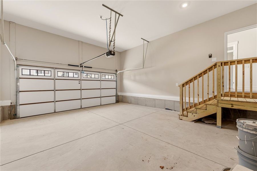 A spacious, clean garage features an automatic doo