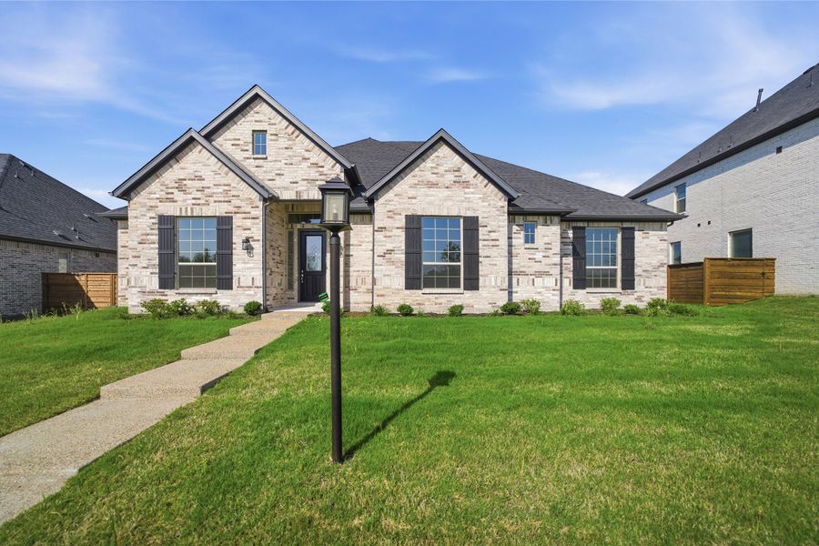 Front exterior of a new home in Solterra, Mesquite, TX, highlighting curb appeal (Image 1). Front exterior of a new home in Solterra, Mesquite, TX, highlighting curb appeal (Image 1).