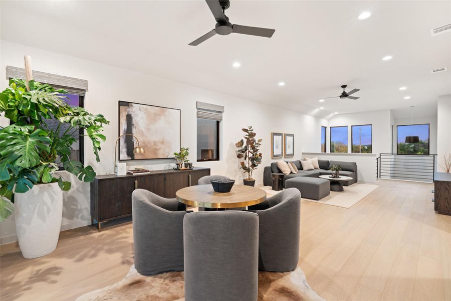 Blonde hardwood floors flow through this luminous open-concept living space, featuring recessed lighting and ample windows. Blonde hardwood floors flow through this luminous open-concept living space, featuring recessed lighting and ample windows.