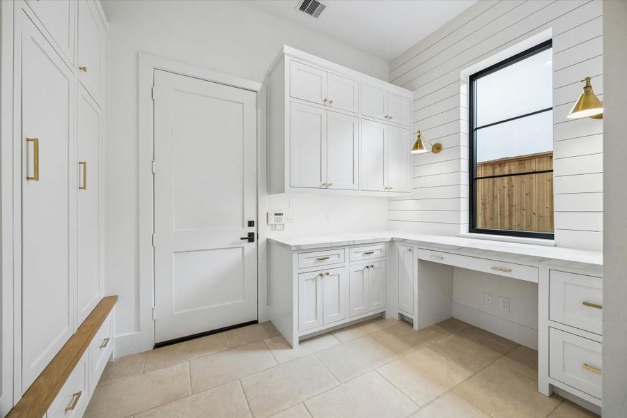 Mud room just off garage with lockers and command center/work space.