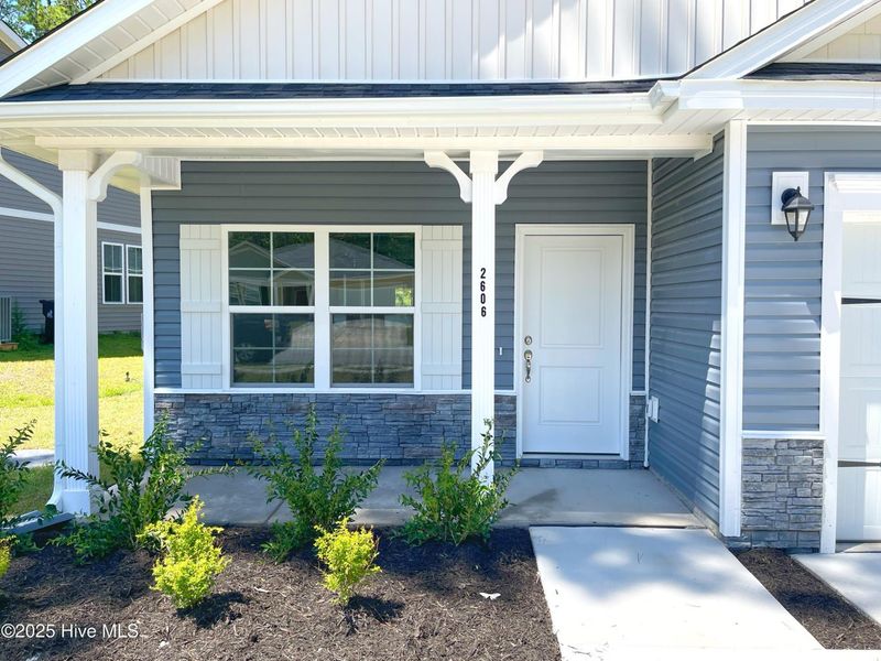 Front exterior of a new home in Mill Creek Cove, Bolivia, NC, highlighting curb appeal (Image 2). Front exterior of a new home in Mill Creek Cove, Bolivia, NC, highlighting curb appeal (Image 2).