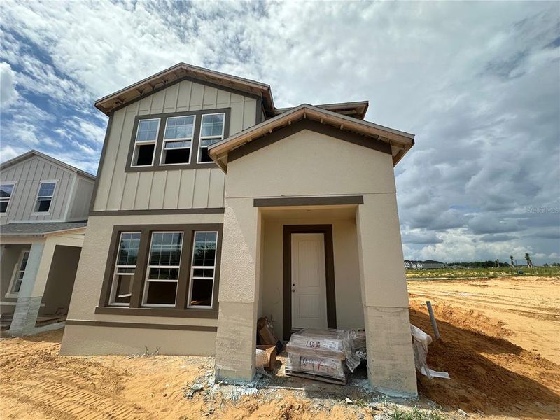 Front exterior of a new home in Lake Star at Ovation, Winter Garden, FL, highlighting curb appeal (Image 1).