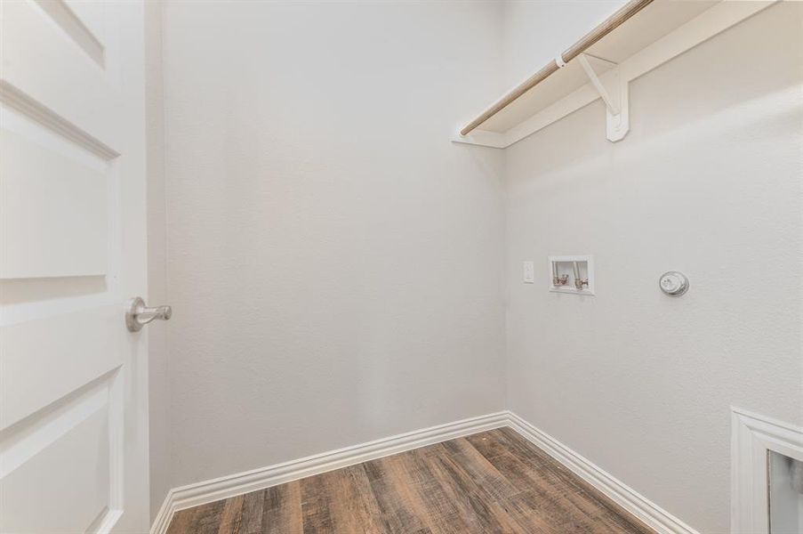 Washroom featuring dark hardwood / wood-style flooring and hookup for a washing machine