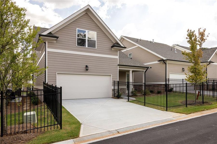 Front exterior of a new home in Evanshire Single Family, Duluth, GA, highlighting curb appeal (Image 23). Front exterior of a new home in Evanshire Single Family, Duluth, GA, highlighting curb appeal (Image 23).