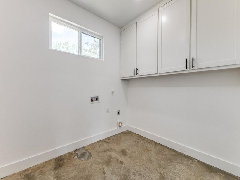 Washroom featuring cabinet space, hookup for a washing machine, baseboards, and hookup for an electric dryer