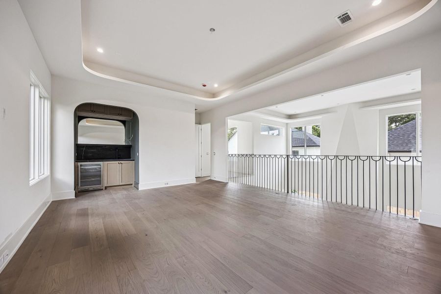Another view of the Game Room, which also features a Wet-Bar on the left. The right side of the room will open to a iron railing overlooking the level below, reinforcing the home's open-concept layout. Construction as of June 1st, 2026.