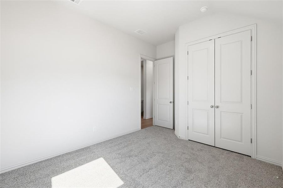 Unfurnished bedroom featuring carpet floors and a closet