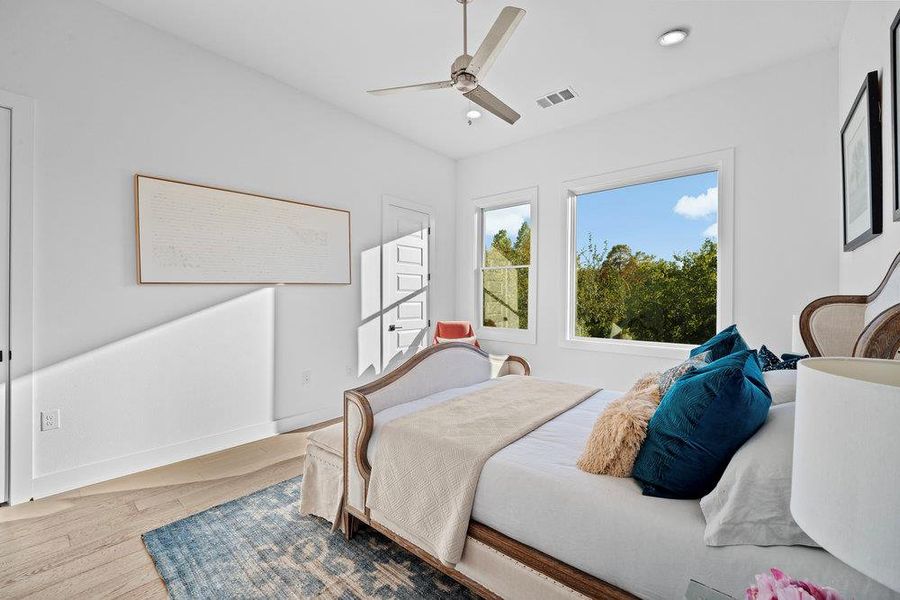 Bedroom featuring wood finished floors, ceiling fan, and recessed lighting Bedroom featuring wood finished floors, ceiling fan, and recessed lighting