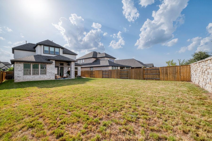 The wide-open yard is ready to enjoy now, or bring those pool, play space, and outdoor kitchen ideas to life.