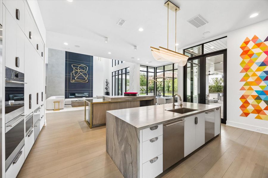 The light fixtures throughout the home are all modern and luxurious. The stone work throughout the kitchen and the bar was a huge expense, with cabinet hardware to match. There is also a large walk in pantry. The light fixtures throughout the home are all modern and luxurious. The stone work throughout the kitchen and the bar was a huge expense, with cabinet hardware to match. There is also a large walk in pantry.