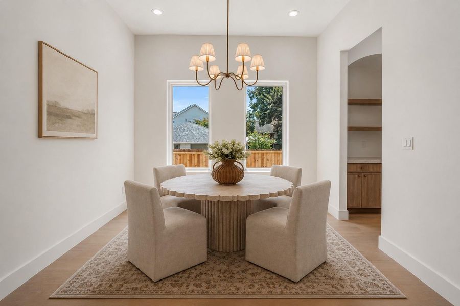 Elegant dining room with beautiful chandelier. Virtual staging.