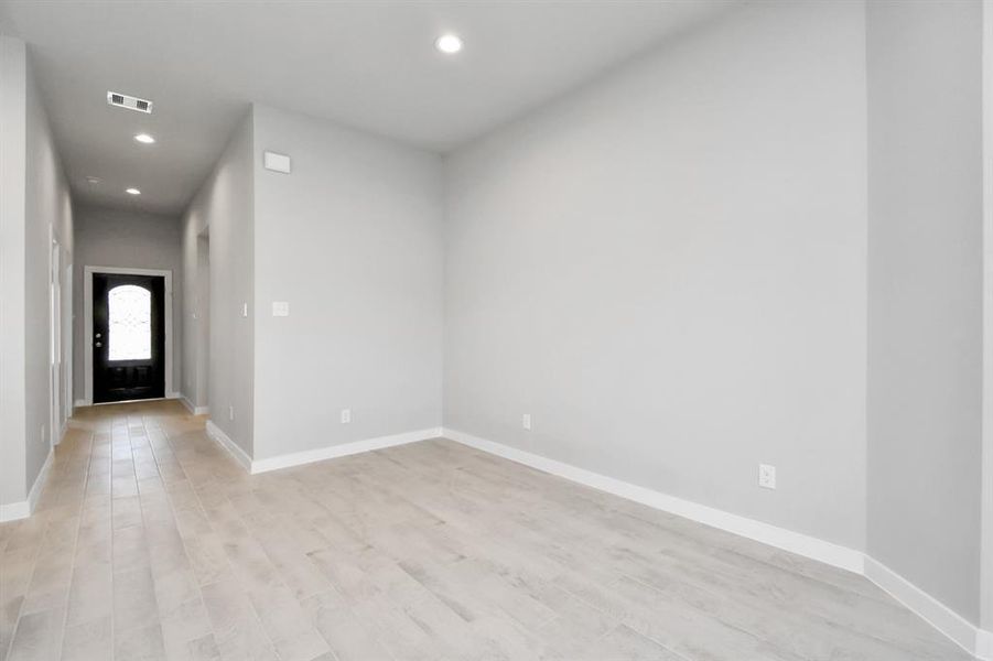 Create lasting memories with your family and friends at the dining table in this dining area. Room showcases sophisticated flooring, custom paint, and seamlessly connects to the family room and kitchen, providing an open and inviting atmosphere.  Sample photo of completed home with similar floor plan. Actual colors and selections may vary.