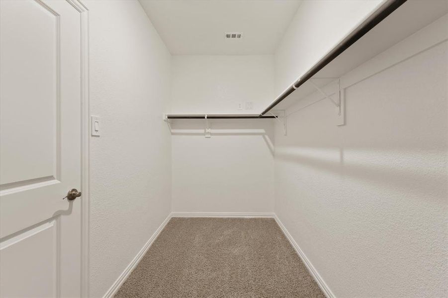 Spacious closet with light carpet Spacious closet with light carpet