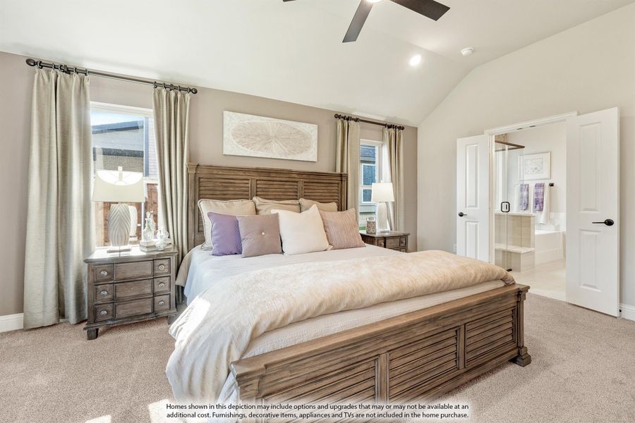 Master bedroom with vaulted ceiling, wood bed frame, ceiling fan, and ensuite bathroom doorway visible Master bedroom with vaulted ceiling, wood bed frame, ceiling fan, and ensuite bathroom doorway visible