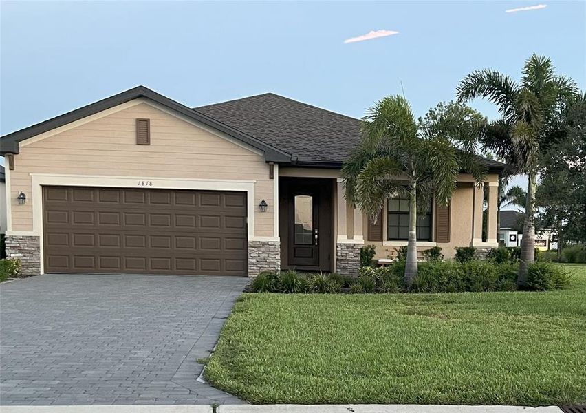 Front exterior of a new home in , Port Charlotte, FL, highlighting curb appeal (Image 1).