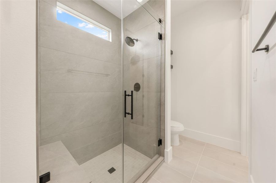 Full bathroom with a stall shower and light tile patterned floors