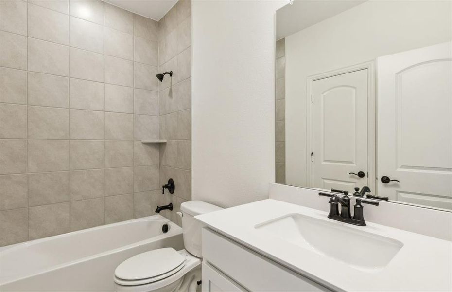 Secondary bathroom featuring modern upgrades and finishes *Real home pictured
