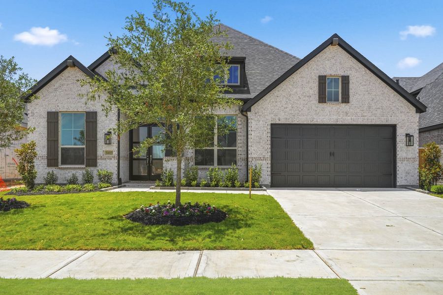 Front exterior of a new home in Cross Creek West, Fulshear, TX, highlighting curb appeal (Image 1). Front exterior of a new home in Cross Creek West, Fulshear, TX, highlighting curb appeal (Image 1).